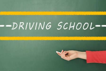 Driving school concept. Woman with white chalk near green board, closeupの写真素材
