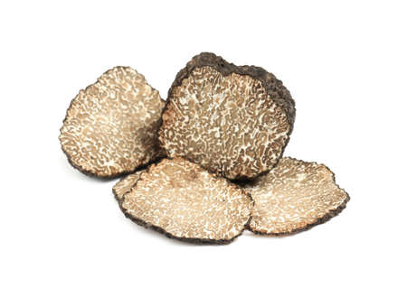 Cut fresh black truffle isolated on whiteの写真素材