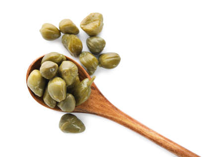 Wooden spoon and capers on white background, top viewの写真素材