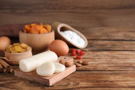 Marzipan and other ingredients for homemade Stollen on wooden table. Baking traditional German Christmas breadの写真素材
