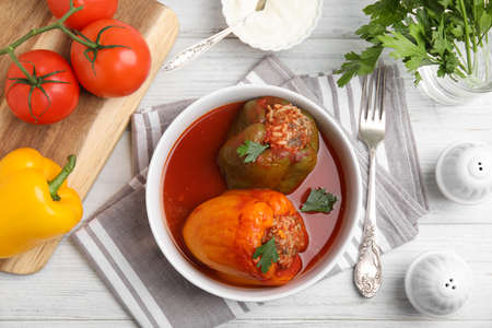 Delicious stuffed peppers served on white wooden table, flat layの写真素材