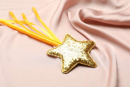 Beautiful golden magic wand on pink fabricの写真素材
