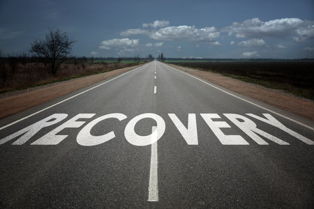Start to live without alcohol addiction. Word RECOVERY on asphalt highwayの写真素材