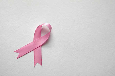 Pink ribbon on white background, top view with space for text. Breast cancer awareness conceptの写真素材