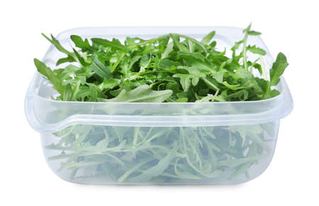 Fresh arugula in plastic container isolated on whiteの写真素材