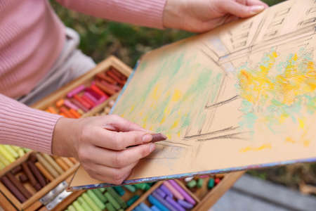 Woman drawing with soft pastels outdoors, closeupの写真素材