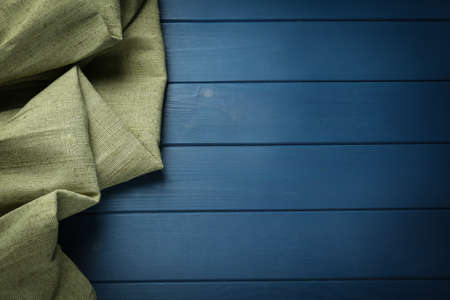 Natural burlap fabric on blue wooden table, top view. Space for textの写真素材