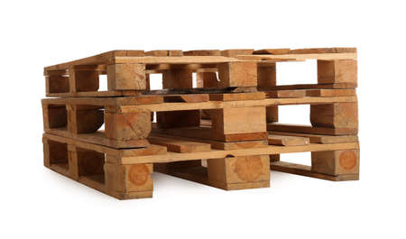 Stacked wooden pallets isolated on white. Transportation and storageの写真素材