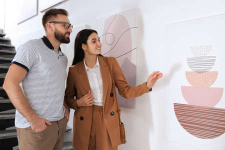 Happy couple at exhibition in art galleryの写真素材