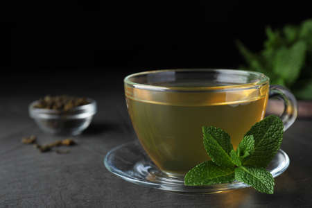 Cup of hot aromatic mint tea on gray tableの写真素材