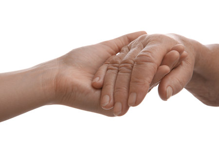 Young and elderly women holding hands together on white background, closeupの写真素材
