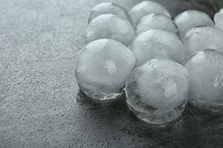 Many frozen ice balls on dark gray table, closeup. Space for textの写真素材