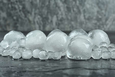Many melting ice balls on dark tableの写真素材