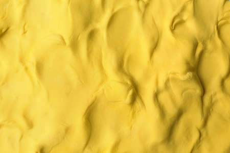 Yellow play dough as background, top viewの写真素材