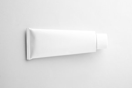 Blank tube of ointment isolated on white, top view