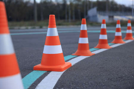 Driving school test track with marking lines, focus on traffic coneの写真素材