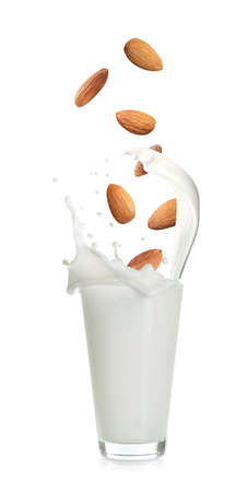 Delicious almond milk and nuts on white backgroundの写真素材