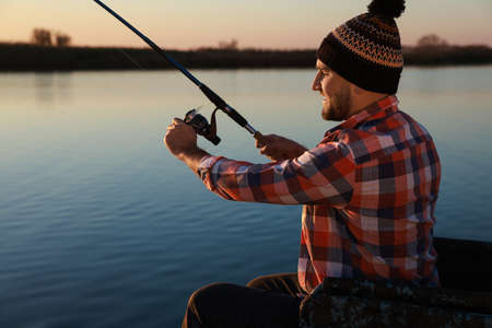 Fisherman with fishing rod at riverside. Recreational activityの写真素材