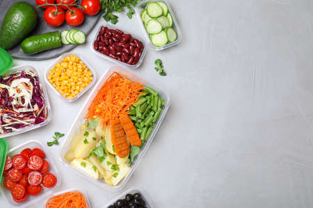 Set of plastic containers with fresh food on light table, flat lay. Space for text