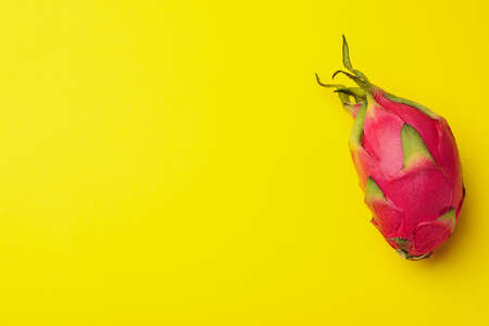 Delicious pitahaya fruit on yellow background, top view. Space for textの写真素材