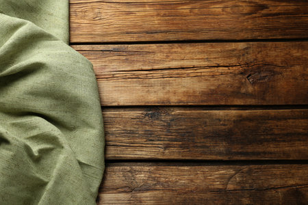 Natural burlap fabric on wooden table, top view. Space for textの写真素材