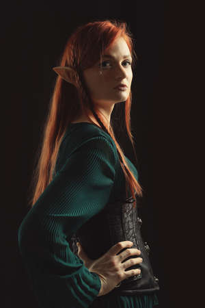 Beautiful redhead elf girl on black backgroundの写真素材