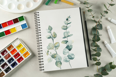 Flat lay composition with beautiful drawing of eucalyptus branches on white tableの写真素材
