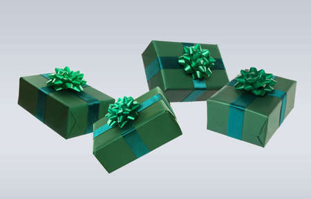 Beautifully wrapped gift boxes flying on light background