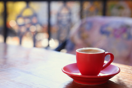 Cup of hot aromatic coffee on table in outdoor cafe. Space for textの写真素材