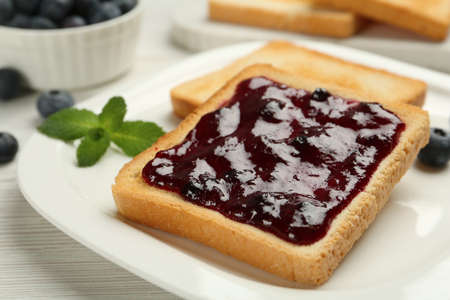 Toast with blueberry jam on white wooden table, closeupの写真素材