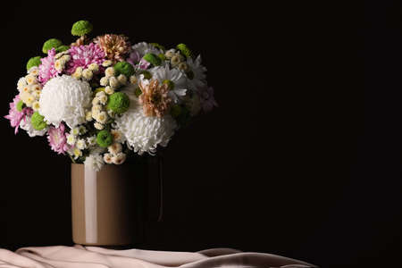Bouquet of beautiful chrysanthemum flowers on table against dark background, space for textの写真素材