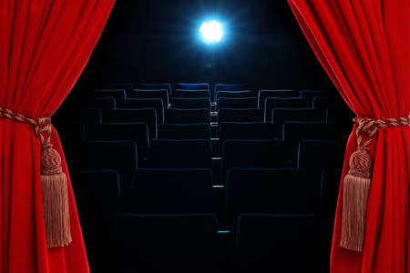 Open elegant red front curtains and hall with empty seats on backgroundの写真素材