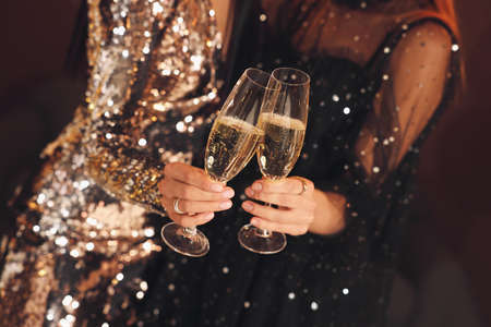 Women with glasses of sparkling wine celebrating New Year indoors, closeupの写真素材
