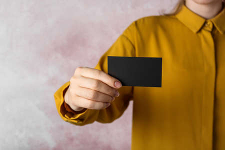Woman holding blank business card on pink background, closeup. Mockup for designの写真素材