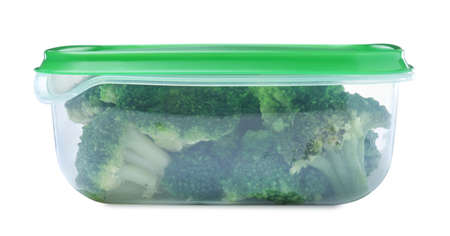 Fresh broccoli in plastic container isolated on whiteの写真素材