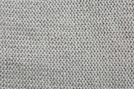 Beautiful gray knitted fabric as background, top view