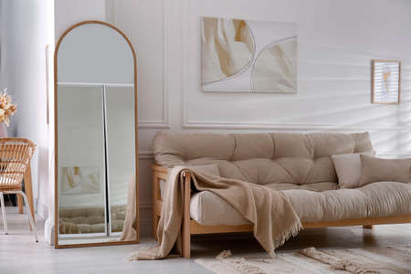 Apartment interior with large mirror and different furnitureの写真素材