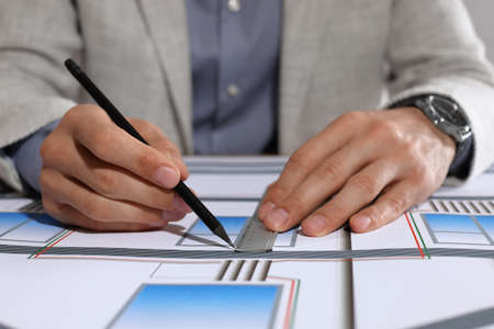 Architect working with construction drawings, closeup view
