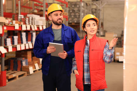 Manager and worker at warehouse. Logistics center