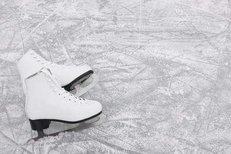 Pair of figure skates on ice, above view. Space for textの写真素材