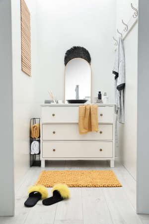 Mat near base cabinet with sink in bathroomの写真素材