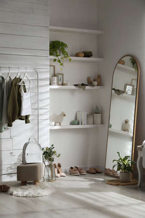 Rack with different stylish clothes, shoes and decorative elements in dressing room. Interior designの写真素材