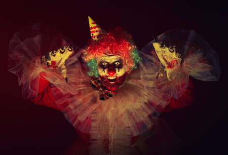 Terrifying clown in darkness. Halloween party costumeの写真素材
