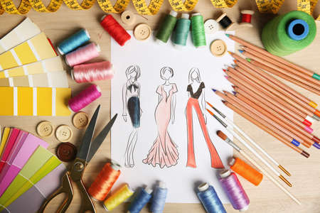 Sketch of fashion clothes and thread supplies at designer's workplace, flat layの写真素材