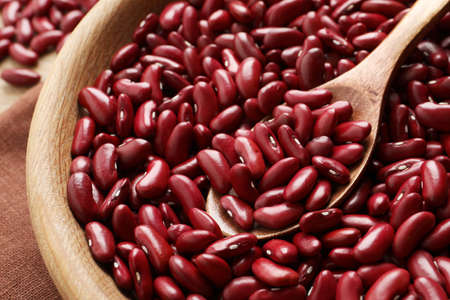 Raw red kidney beans with spoon in wooden bowl, closeupの写真素材