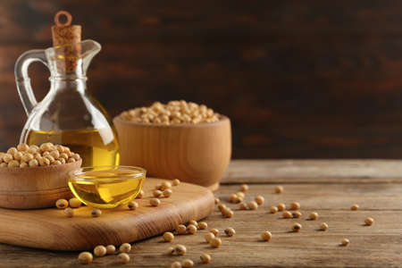 Composition with soybean oil on wooden table, space for textの写真素材