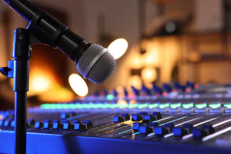 Microphone near professional mixing console in radio studio, closeupの写真素材