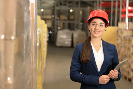 Manager with tablet working at warehouse. Logistics center