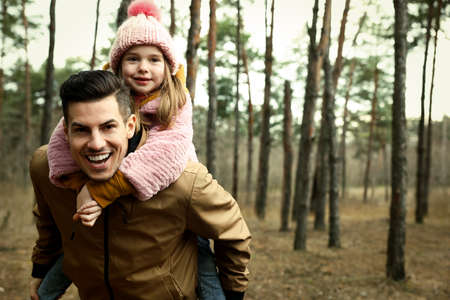 Man and his daughter spending time together in forestの写真素材