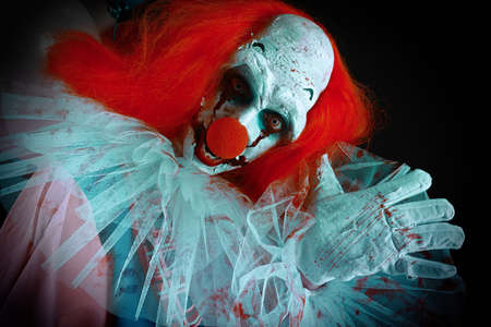 Terrifying clown on black background. Halloween party costume